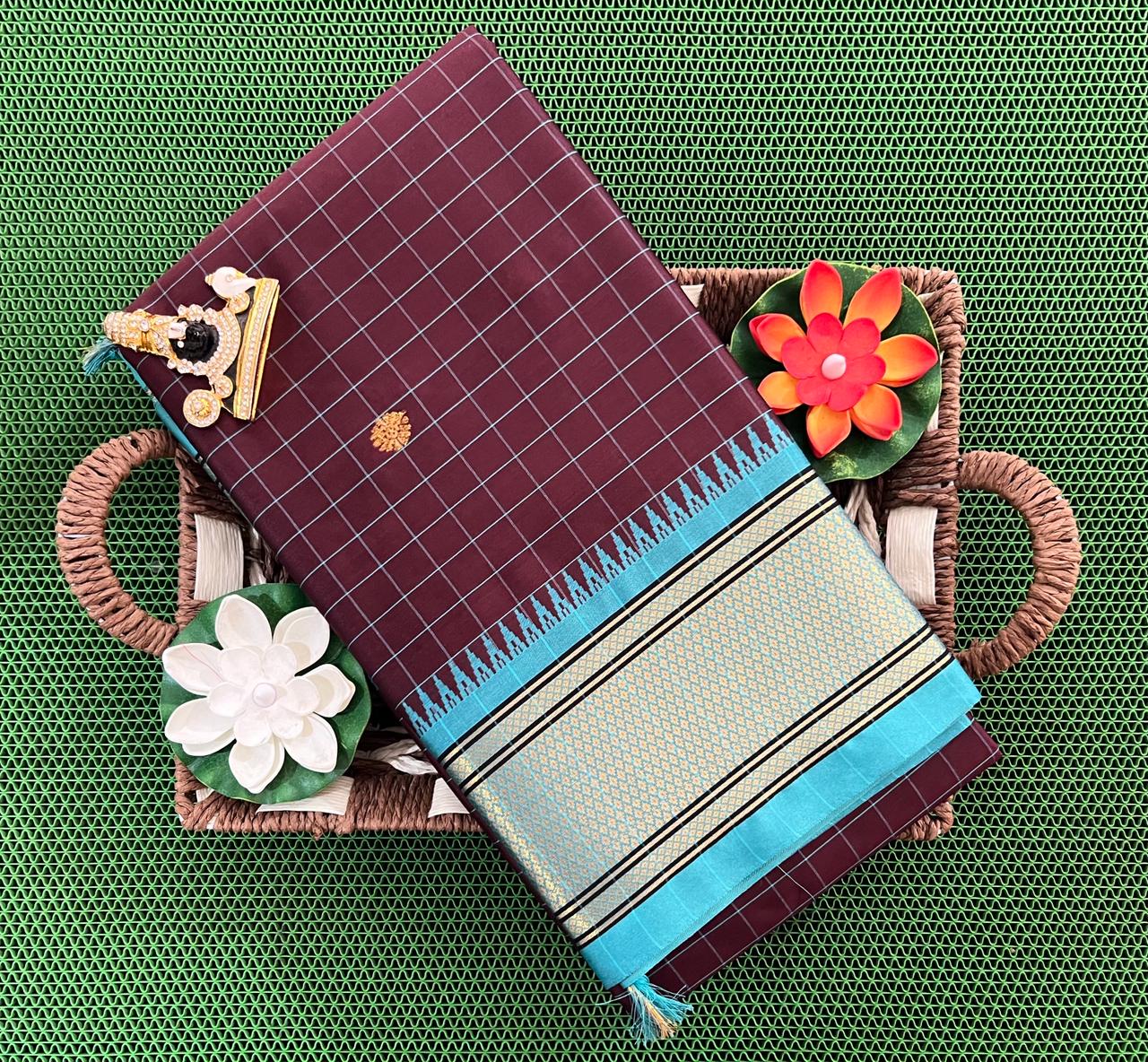 KANJIVARAM SAREES A luxurious Kanjivaram silk saree with intricate checks and butta designs in vibrant colors