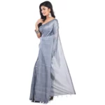 Woman wearing a plain grey saree.