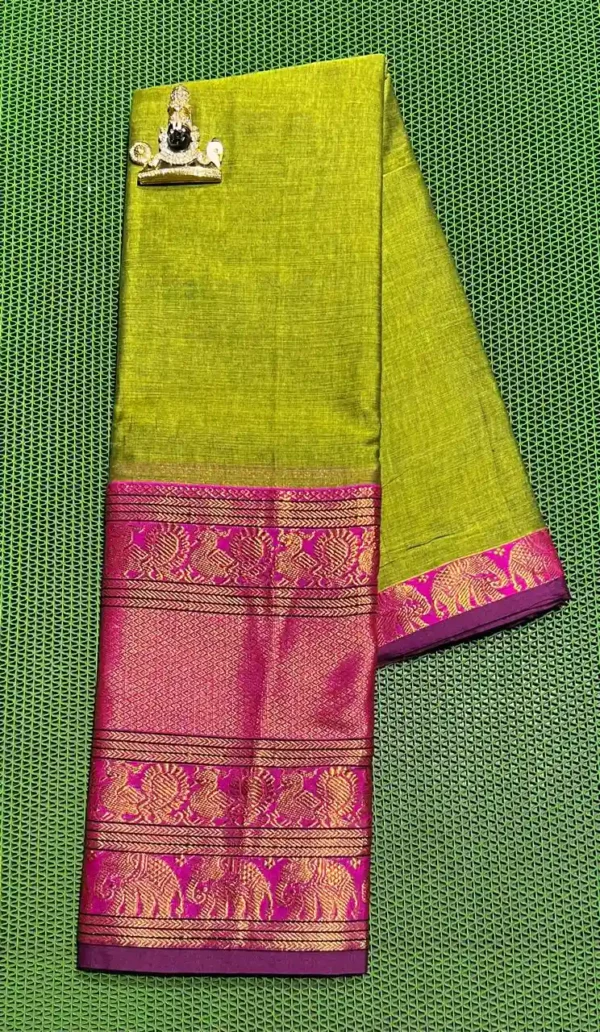 A folded green Narayanpet sarees with a contrasting pink border. The border features intricate gold zari designs of elephants and other motifs. The saree has a rich texture and a subtle sheen.
