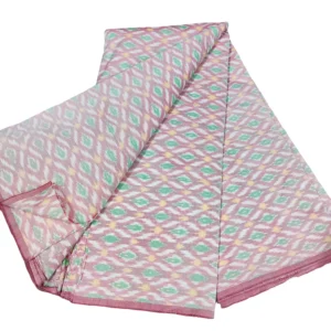 cotton silk fabric with a traditional ikat pattern featuring multicolored diamond motifs arranged in a symmetrical design."