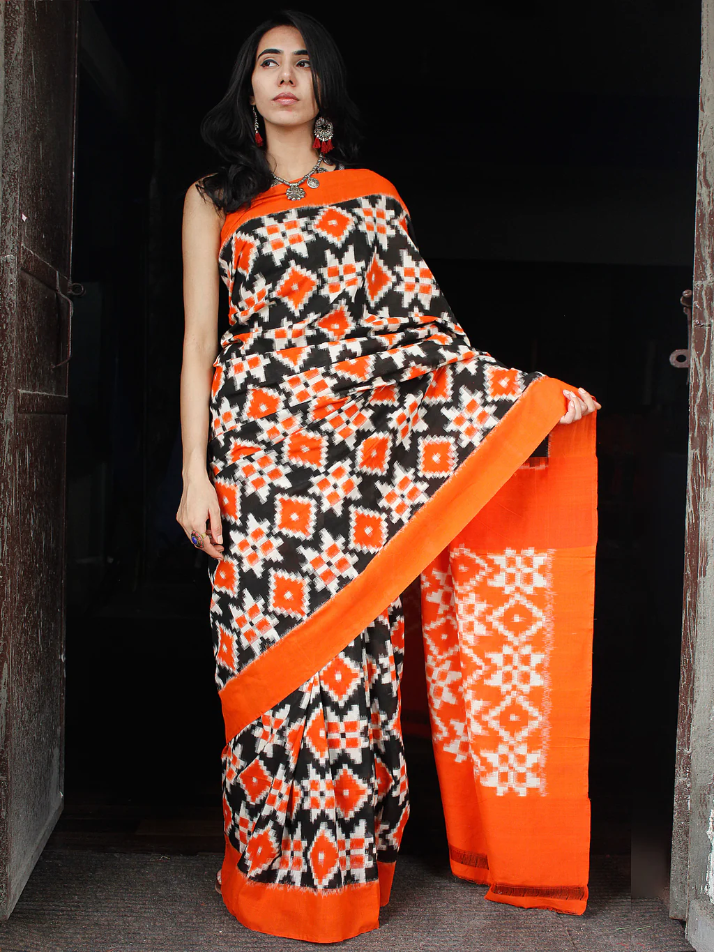 s7-1_08e38881-3eb8-4d36-9364-94ca9ecca96c_1024x Theliya Rumal Saree in orange & amp; Black – Handwoven Double Ikat Cotton Saree with Blouse, 6.2 Meters - Image 1