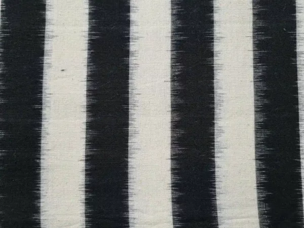 Handwoven double ikat fabric in vibrant tie-and-dye patterns, 45-inch width