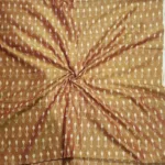 Tie and dye cotton fabric with intricate ikat patterns on a loom