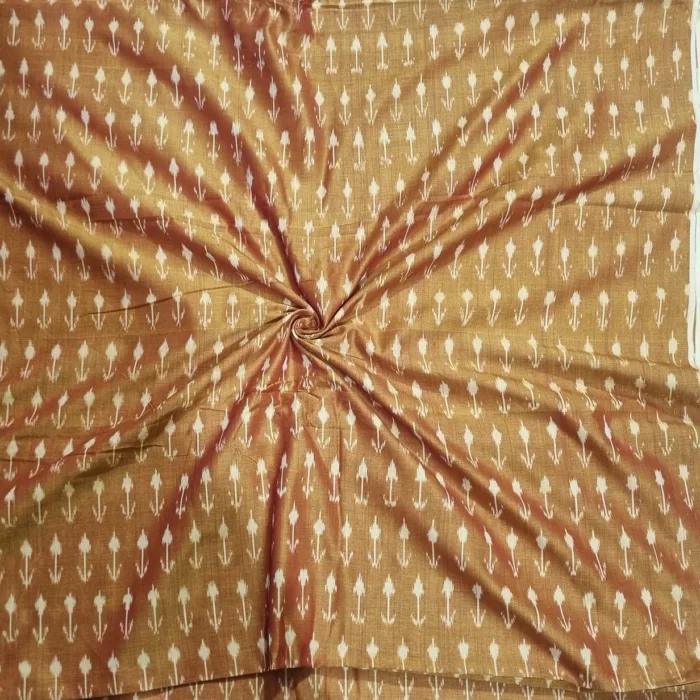 Tie and dye cotton fabric with intricate ikat patterns on a loom