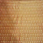 Tie and dye cotton fabric with intricate ikat patterns on a loom