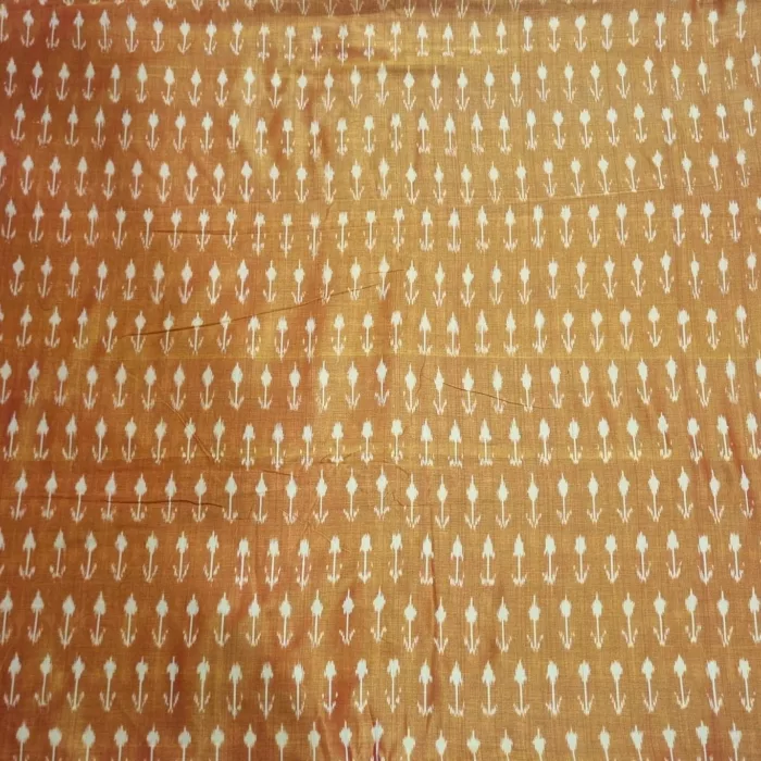 Tie and dye cotton fabric with intricate ikat patterns on a loom