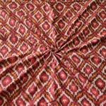 Handwoven Pochampally ikat fabric with red, mustard, and white diamond pattern, traditional geometric design on cotton or cotton-silk textile.