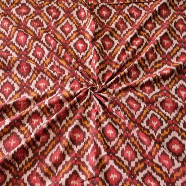 Handwoven Pochampally ikat fabric with red, mustard, and white diamond pattern, traditional geometric design on cotton or cotton-silk textile.