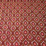 Handwoven Pochampally ikat fabric with red, mustard, and white diamond pattern, traditional geometric design on cotton or cotton-silk textile.