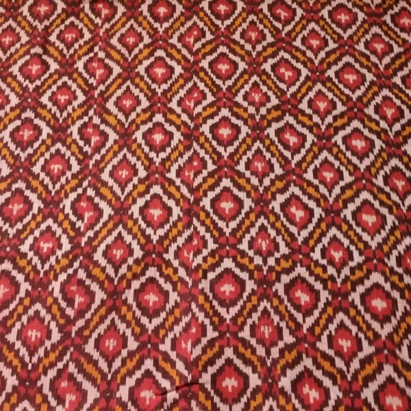 Handwoven Pochampally ikat fabric with red, mustard, and white diamond pattern, traditional geometric design on cotton or cotton-silk textile.